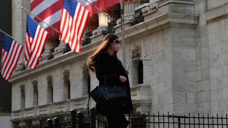 A person walks past the New York Stock Exchange (NYSE) at Wall Street on November 16, 2020 in New York City