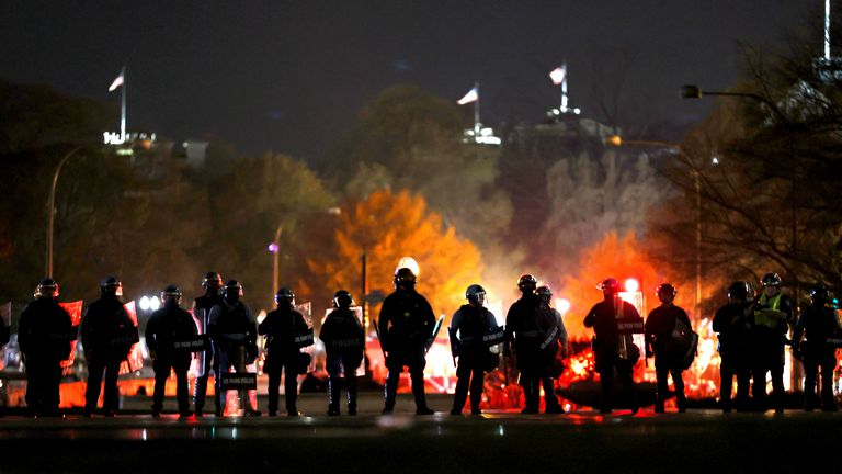 Police officers stand in line as they monitor a protest following the “Million MAGA March” from Freedom Plaza to the Supreme Court, on November 14, 2020 in Washington, DC. 