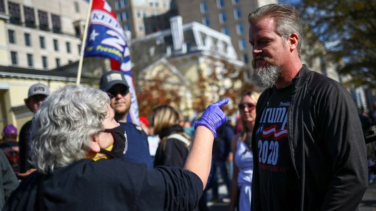 A person gestures at a counter-demonstrator and supporter of U.S. President Donald Trump during an anti-Trump rally in the aftermath of the 2020 U.S. presidential election, at Black Lives Matter Plaza in Washington, U.S., November 13, 2020
