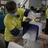 Claps and whistles as first doses of COVID vaccine hit the road in the US