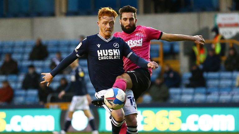 LONDON, ENGLAND - DECEMBER 05: Ryan Woods of Millwall battling for possession with Graeme Shinnie of Derby County during the Sky Bet Championship match between Millwall and Derby County at The Den on December 05, 2020 in London, England. A limited number of fans are welcomed back to stadiums to watch elite football across England. This was following easing of restrictions on spectators in tiers one and two areas only. (Photo by Jacques Feeney/Getty Images)