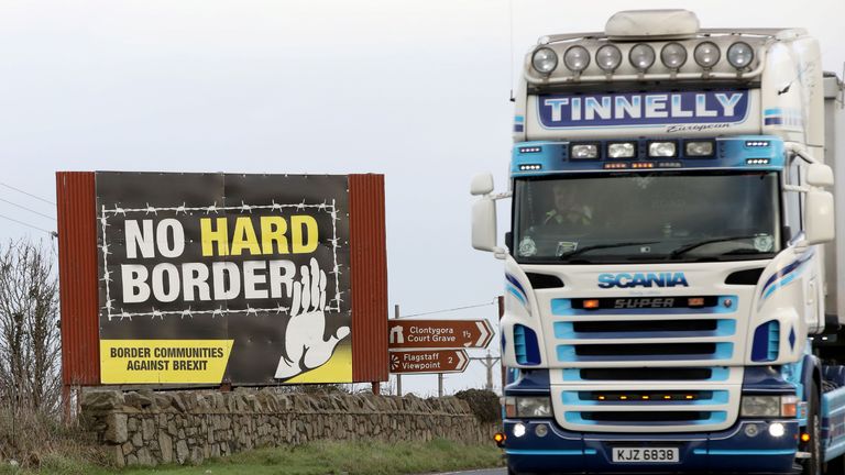 Traffic passes an "No Hard Border" anti-Brexit, pro-Irish unity billboard poster as it crosses the border road between Newry in Northern Ireland, on February 1, 2020, and Dundalk in Ireland. - Britain began its post-Brexit uncertain future outside the European Union on Saturday after the country greeted the historic end to almost half a century of EU membership with a mixture of joy and sadness. There were celebrations and tears on Friday as the EU's often reluctant member became the first to leave an organisation set up to forge unity among nations after the horrors of World War II. (Photo by Paul Faith / AFP) (Photo by PAUL FAITH/AFP via Getty Images)