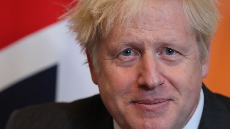 Britain's Prime Minister Boris Johnson sits in front of a Union flag as he talks with Abu Dhabi's Crown Prince Sheikh Mohammed bin Zayed al-Nahyan inside 10 Downing Street in central London on December 10, 2020. (Photo by Gareth Fuller / POOL / AFP) (Photo by GARETH FULLER/POOL/AFP via Getty Images)