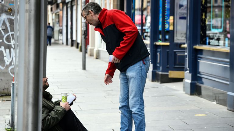 Former drug user-turned-drug policy campaigner Peter Krykant distributes flyers to addicts and homeless people, promoting his  "Safe Consumption" van, a mobile sterile drugs consumption facility he runs, in Glasgow on September 9, 2020. - In the shade of the buildings at the bottom end of a secluded street in central Glasgow, Peter Krykant gets out of his converted white minibus and glances up an adjacent alleyway. Drug spoons, bloody syringes and human excrement litter the ground. Krykant, 43, knows these streets well. Before he gave up drugs 11 years ago, he was homeless and would inject cocaine and heroin in places just like these. (Photo by ANDY BUCHANAN / AFP) (Photo by ANDY BUCHANAN/AFP via Getty Images)
