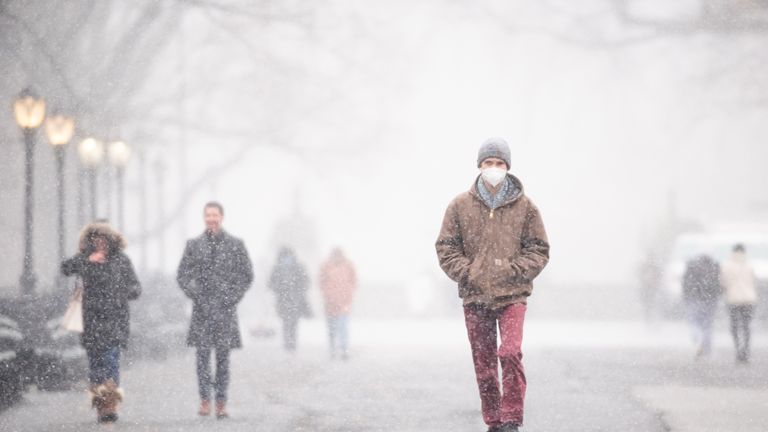 NEW YORK, NEW YORK - DECEMBER 09: People walk in The Mall in Central Park during the first snow of the season on December 09, 2020 in New York City. The pandemic has caused long-term repercussions throughout the tourism and entertainment industries, including temporary and permanent closures of historic and iconic venues, costing the city and businesses billions in revenue. (Photo by Noam Galai/Getty Images)