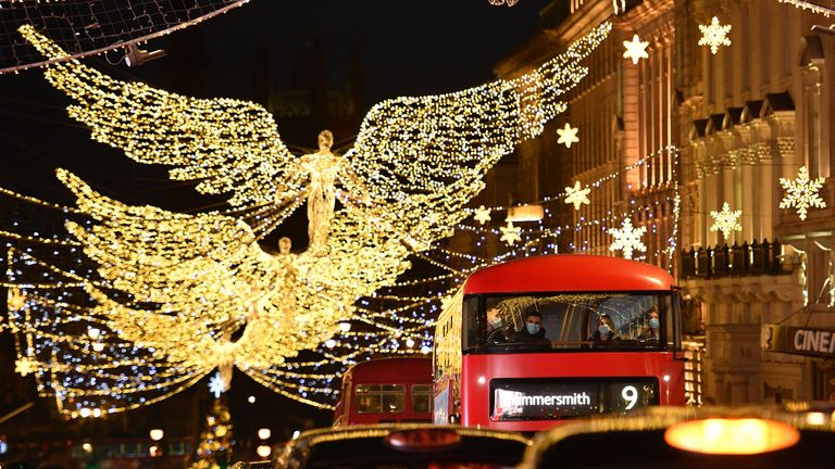 Christmas lights twinkle as passengers travel in a bus along Piccadilly, London on December 12, 2020, as with under two weeks to Christmas, people take advantage of the easing of England's restrictions on shop openings to combat the spread of the novel coronavirus. (Photo by JUSTIN TALLIS / AFP) (Photo by JUSTIN TALLIS/AFP via Getty Images)