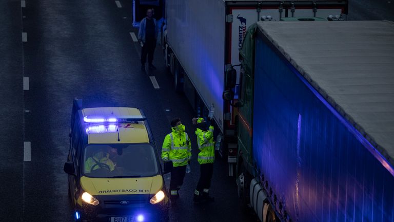 SELLINDGE, ENGLAND - DECEMBER 21: The coastguard give out bottles of water as lorries queue on the M20 on December 21, 2020 in Sellindge, England. Citing concern over a new covid-19 variant and England's surge in cases, France temporarily closed its border with the UK late Sunday, halting freight and ferry departures from the port of Dover for 48 hours. France also joined several other European countries in stopping rail and air travel from the UK. (Photo by Dan Kitwood/Getty Images)