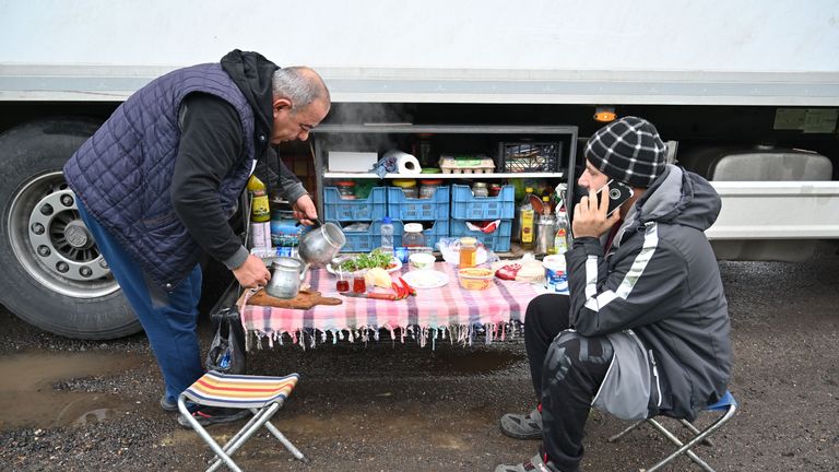 Turkish long-haul truck drivers sit down to breakfast at a truck stop off the M20 motorway which leads to the Port of Dover, near Ashford in Kent, south east England on December 22, 2020, as they queue unable to continue their journeys after France closed its borders to accompanied freight arriving from the UK due to the rapid spread of a more-infectious new coronavirus strain. - Britain sought to sound a note of calm saying they were working as fast as possible to unblock trade across the Channel after France shut its borders to UK hauliers in a bid to contain a new variant of the coronavirus. (Photo by JUSTIN TALLIS / AFP) (Photo by JUSTIN TALLIS/AFP via Getty Images)