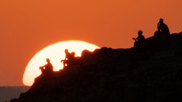 Ethiopian refugees who fled Ethiopia's Tigray conflict watch the sunset on a hill in Um Raquba refugee camp in Gedaref state, eastern Sudan, on December 12, 2020 (Photo by Yasuyoshi CHIBA / AFP) (Photo by YASUYOSHI CHIBA / AFP via Getty Images)