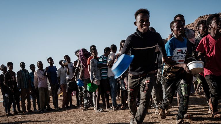 Ethiopian refugees who fled the Ethiopia's Tigray conflict wait in a line for the food distribution by Muslim Aid at the Um Raquba refugee camp in Sudan's eastern Gedaref state on December 12, 2020. (Photo by Yasuyoshi CHIBA / AFP) (Photo by YASUYOSHI CHIBA/AFP via Getty Images)