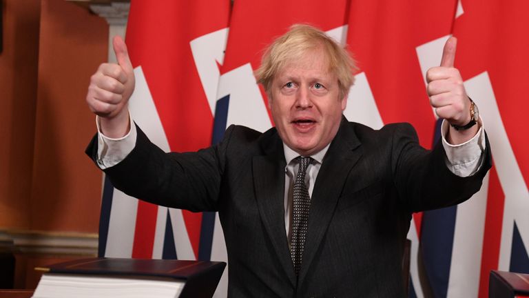 Prime Minister Boris Johnson gives a thumbs up gesture after signing the EU-UK Trade and Cooperation Agreement at 10 Downing Street, Westminster.