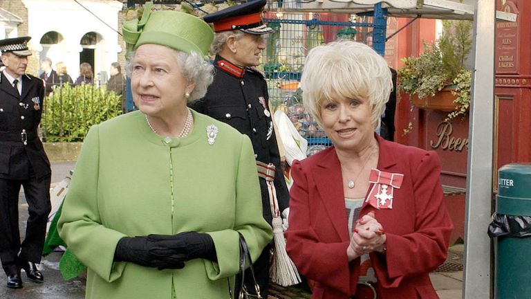 LONDON - NOVEMBER 28: Queen Elizabeth ll is shown around by star Barbara Windsor as she visits the set of the soap &#39;Eastenders&#39; on November 28, 2001 in London, England. (Photo by Anwar Hussein/Getty Images)