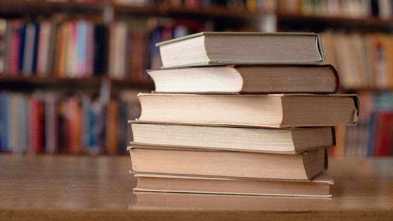 Close up of books on a desk in a library