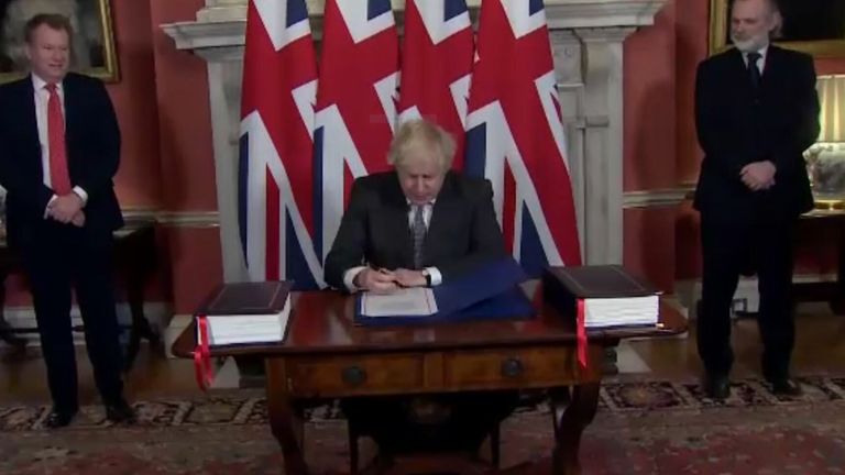 Boris Johnson signs the EU-Uk trade agreement in Downing Street