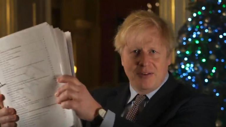 Boris Johnson brandishes the Brexit agreement during his Christmas message Pic: Downing Street