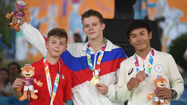 France&#39;s b-boy silver medal Martin (L), Russia&#39;s b-boy gold medal Bumblebee (C) and Japan&#39;s b-boy bronze medal Shigelix (R) pose in the podium at the Youth Olympic Games in Buenos Aires, Argentina on October 08, 2018.