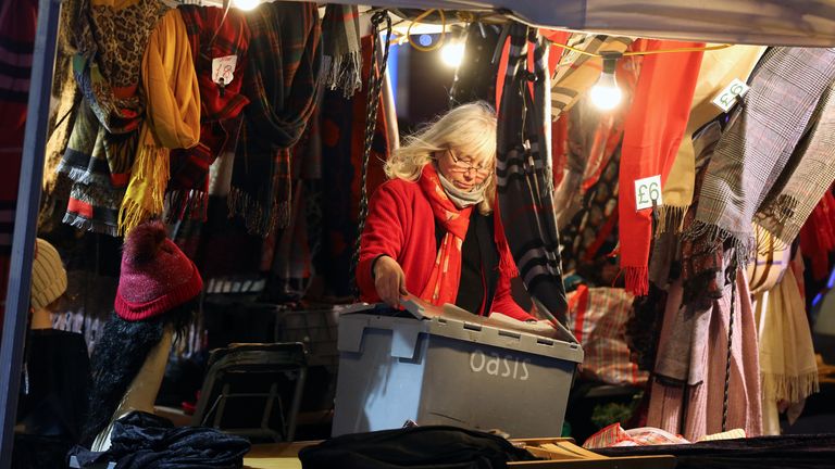 A market stall holder clears her stall in Canterbury, Kent, on the last Saturday shopping day before Christmas, after the county was put into Tier 4 following a sharp rise in Covid-19 cases. Boris Johnson has cancelled Christmas for millions of people across London and south-east England after scientists said that a new coronavirus variant is spreading more rapidly.