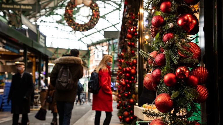 Stallholders in Borough Market, London, prepare for Christmas
