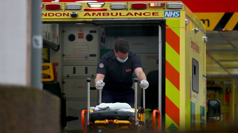 LONDON, ENGLAND - DECEMBER 28: A paramedic moves a stretcher inside an ambulance at St Thomas&#39; Hospital on December 28, 2020 in London, United Kingdom. Patient demand for the London Ambulance Service is "now arguably greater" than during the first wave, according to an internal message recently sent to LAS staff. The UK is experiencing a surge in COVID-19 cases amid reports of a new variant of the virus that may be faster spreading. (Photo by Hollie Adams/Getty Images)
