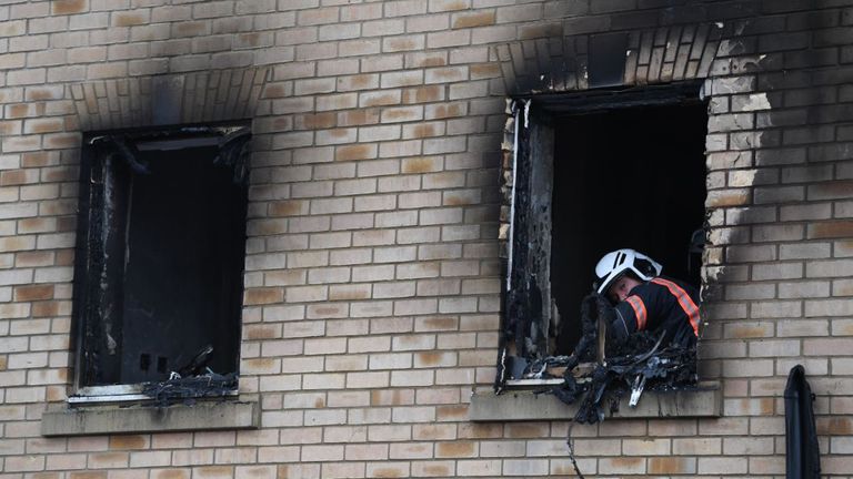 A fire investigator in the burnt out window of a house fire on Buttercup Avenue, Eynesbury, Cambridgeshire, where a three-year-old boy and a seven-year-old girl died. A 35-year-old woman and a 46-year-old were also injured in the fire at the three-storey house, which police believe broke out around 7am Thursday morning. Pic: PA