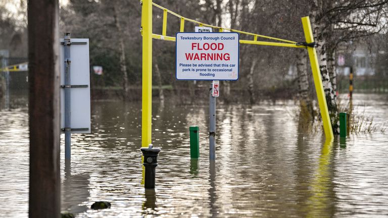 A flood warning sign at the entrance to a flooded car park beside Tewkesbury Abbey, where flood watches are in place with more wet weather expected in the coming days.
