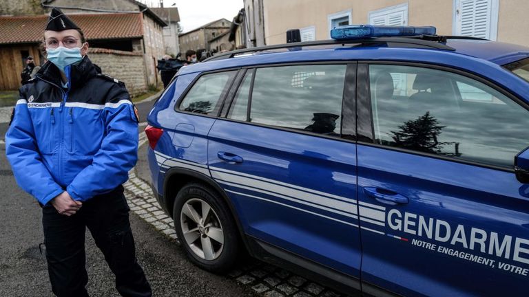  French Gendarme looks on next to a Gendarmerie car in Saint-Just, central France on December 23, 2020, after three gendarmes were killed and a fourth wounded by a gunman they confronted in response to a domestic violence call. - The suspect, a 48-year-old man known to authorities for child custody disputes, was "discovered dead" several hours after fleeing the home in an isolated hamlet near Saint-Just,