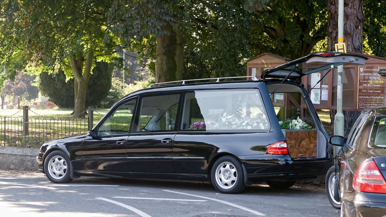 lack hearse outside Pontesbury church during a family funeral