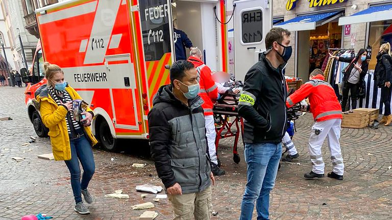 Police look on as rescuers push an injured person into an ambulance at the scene where a car drove into pedestrians in Trier, southwestern Germany, on December 1, 2020. - At least two people were killed and several injured when a car drove into a pedestrian zone in the southwestern German city of Trier on December 1, 2020, police said, adding that the driver had been arrested. (Photo by Sebastian SCHMITZ / various sources / AFP) (Photo by SEBASTIAN SCHMITZ/AFP via Getty Images)