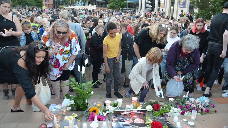 People place tributes during a vigil for British backpacker Grace Millane in Wellington, NZ on Wednesday, December 12, 2018. (AAP Image/ Boris Jancic)