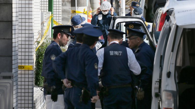 Policemen prepare for inspection in front of an apartment in Zama, Kanagawa prefecture, on November 2, 2017, where police found nine dismembered corpses. Takahiro Shiraishi, the Japanese man who has reportedly confessed to murdering and hacking up nine young people in his bathroom, was said to be a quiet schoolboy who would grow up to be a sex scout and suspected serial killer. / AFP PHOTO / JIJI PRESS / STR / Japan OUT (Photo credit should read STR/AFP via Getty Images)