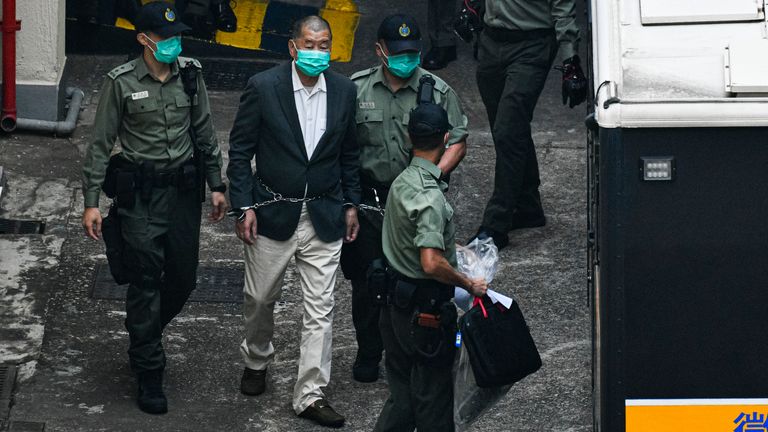 Hong Kong media tycoon Jimmy Lai is seen handcuffed and escorted by the guards leaving prison