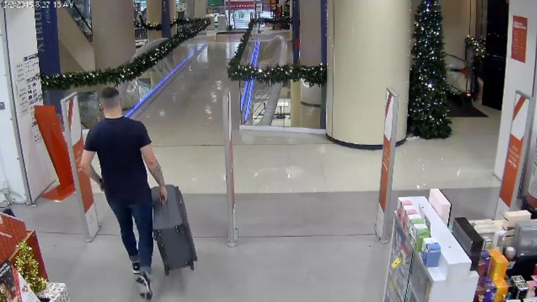 Kempson is seen buying a large suitcase from a store 
