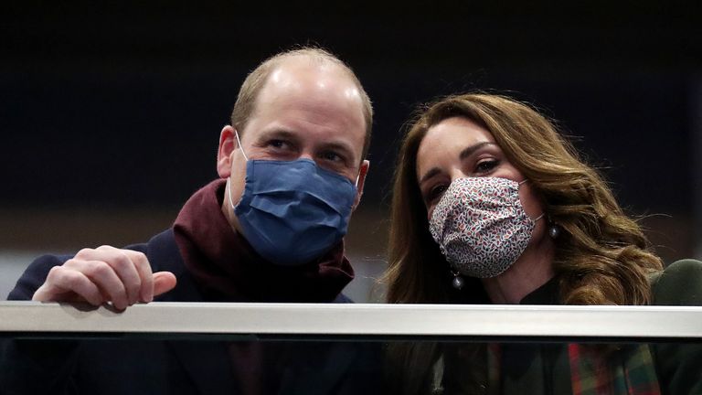 The Duke and Duchess of Cambridge look on from the balcony at London Euston Station ahead of boarding the royal train as they leave London for a tour across the UK.