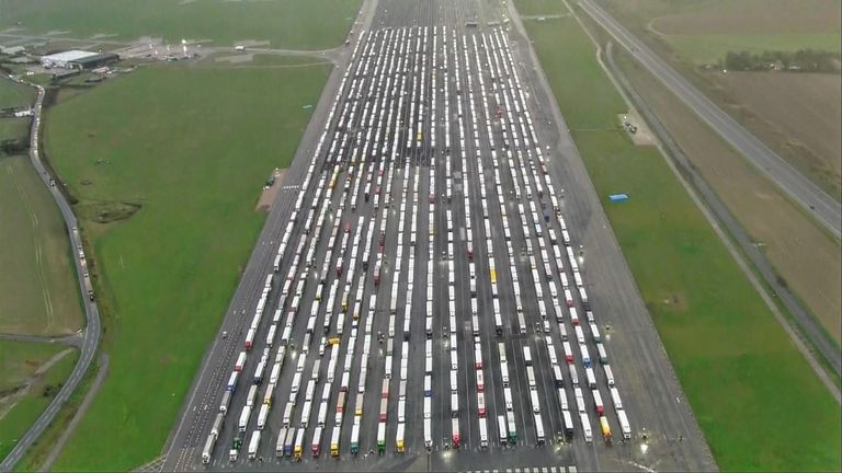 Hundreds of backed-up lorries queue to cross the Channel into France as a former airfield turns into a makeshift lorry park.