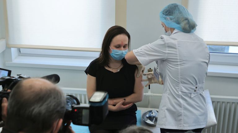 A woman receives her Sputnik V coronavirus vaccine at a clinic in Moscow 