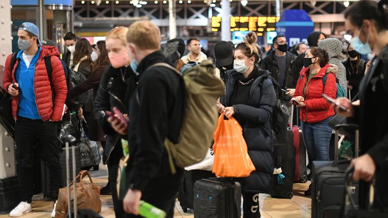 People wait on the concourse at Paddington Station in London, on the last Saturday shopping day before Christmas, after the announcement that London will move into Tier 4 Covid restrictions from midnight.