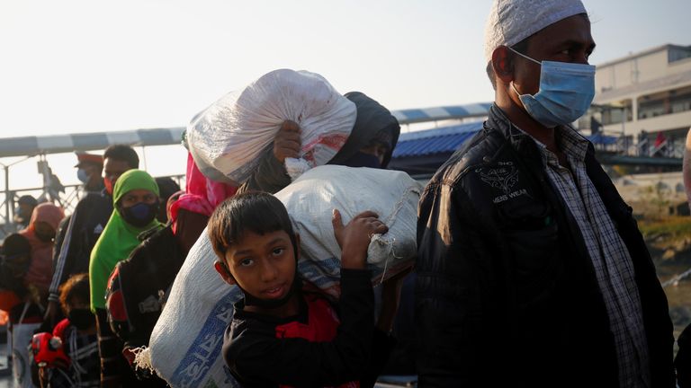 Rohingyas prepare to board a ship as they move to Bhasan Char island near Chattogram
