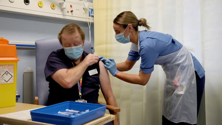 A nurse in Edinburgh administers one of Scotland&#39;s first coronavirus jabs