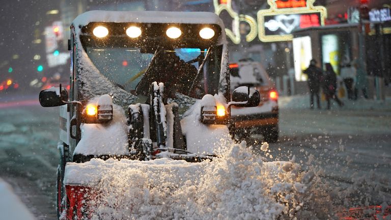 Worker clears snow in Times Square, New York City, New York