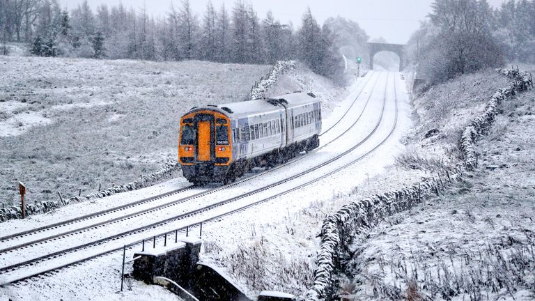 A train runs along the tracks in snowy North Yorkshire with the UK expecting more wintry weather ahead of the first weekend of December, with warnings in place for ice and snow.