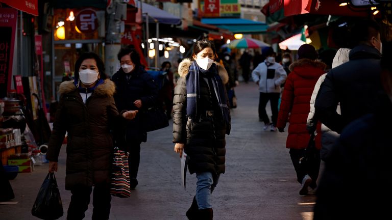 FILE PHOTO: People shop amid the coronavirus disease (COVID-19) pandemic at a traditional market in Seoul, South Korea, December 8, 2020. REUTERS/Kim Hong-Ji/File Photo