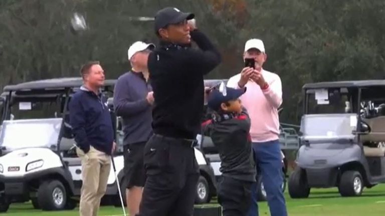 Tiger Woods and son demonstrate their swing