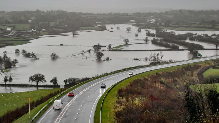 Flooded fields as the River Towy bursts its banks in Carmarthenshire after the Met Office warned that torrential rain is expected to cause flooding in some parts of the UK.