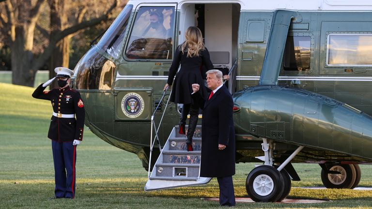 FILE PHOTO: U.S. President Donald Trump, accompanied by first lady Melania Trump, makes a fist as he prepares to board Marine One to depart from the White House for holiday travel to his home in Florida, in Washington, U.S., December 23, 2020. REUTERS/Jonathan Ernst/File Photo