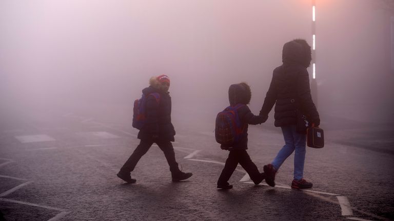 NORTHWICH, ENGLAND - DECEMBER 4: A family heads to school as freezing temperatures create a cold and foggy start in parts of England and Wales on December 4, 2018 in Northwich, England.  (Photo by Christopher Furlong / Getty Images)
