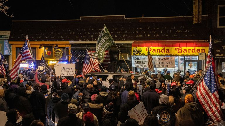 People demonstrate outside a now-shut restaurant against coronavirus restrictions