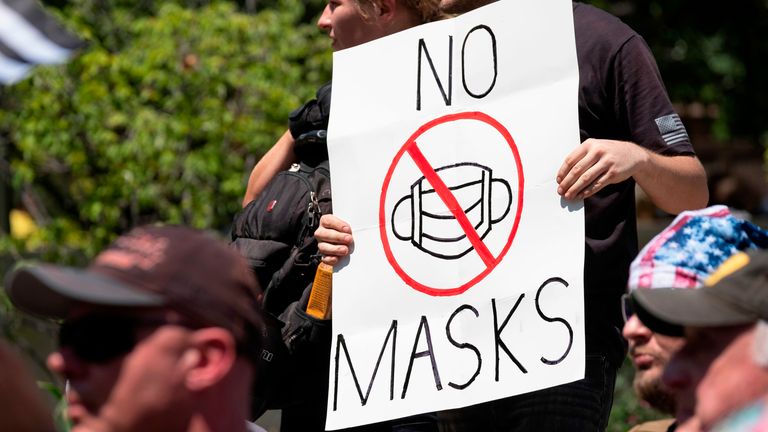 An anti-mask protestor holds up a sign in front of the Ohio Statehouse during a right-wing protest "Stand For America Against Terrorists and Tyrants" at State Capitol on July 18, 2020 in Columbus, Ohio