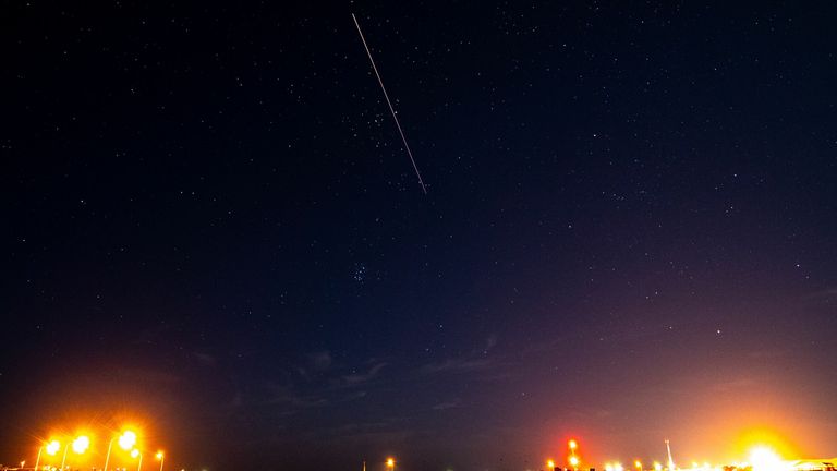 A long exposure shows the light trail of a re-entry capsule, carrying samples collected from a distant asteroid after being released by Japanese space probe Hayabusa-2, entering the Earth&#39;s atmosphere as seen from Coober Pedy in South Australia early on December 6, 2020.