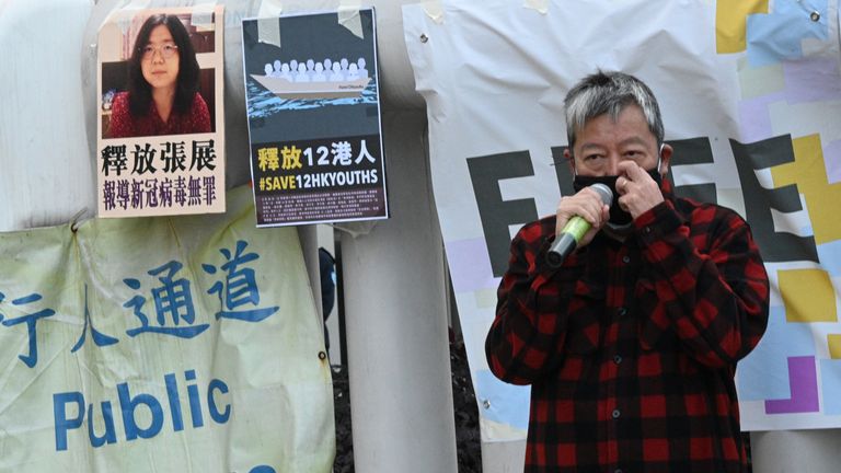 Democracy activist Lee Cheuk-Yan speaks outside China's Liaison Office in Hong Kong on December 28, 2020, during a protest calling on China to free a group of Hong Kong democracy activists facing trial in China, after they attempted to flee the territory by speedboat to Taiwan last August, as well as Chinese citizen journalist Zhang Zhan (top L poster) who was jailed for four years for her livestream reporting from Wuhan as the Covid-19 outbreak unfurled.