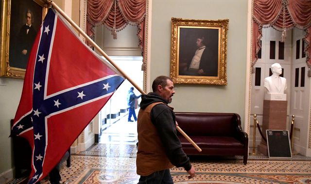 US Capitol: Man pictured carrying Confederate flag charged after his son brags to co-worker - Vimarsana News